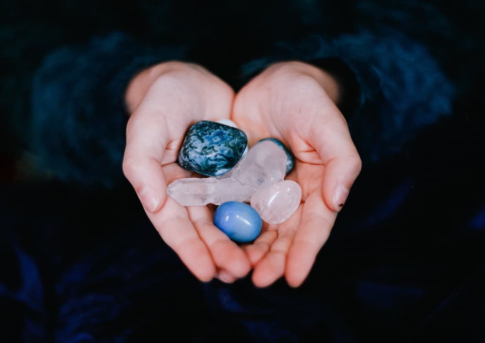 person holding crystals in hands