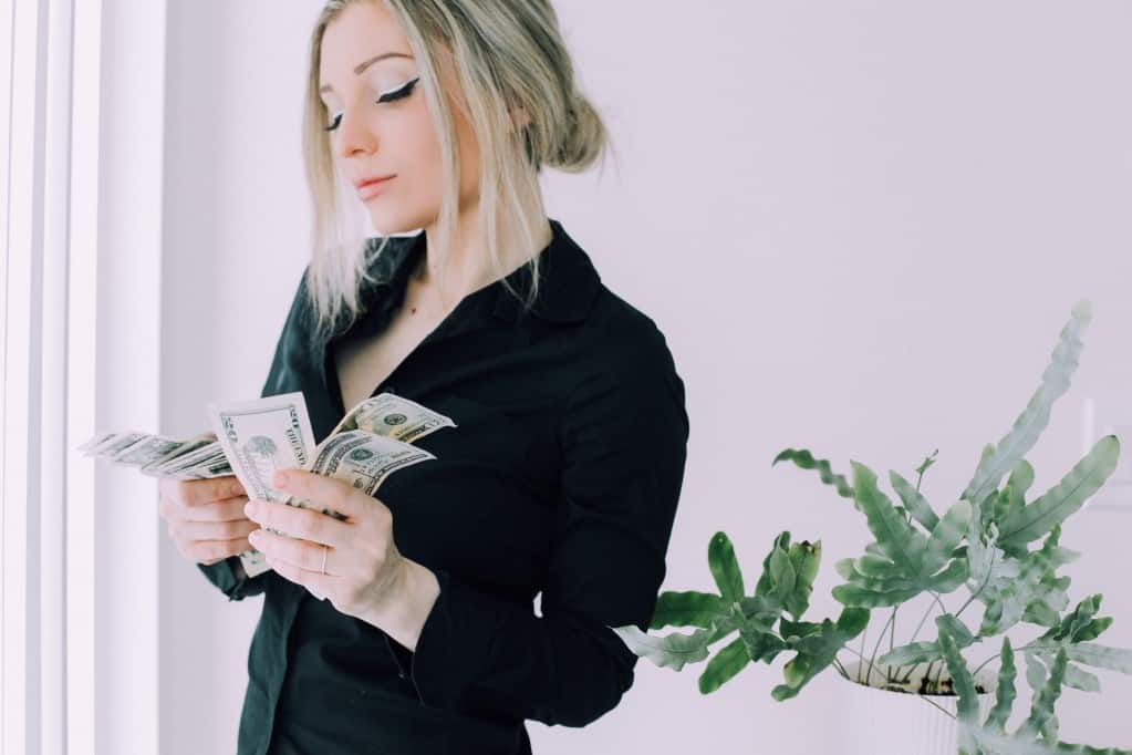 woman-counting-money-holding-money-american-dollars-business-woman-spending-money-woman-thinking-how_t20_YwVn20 woman counting money