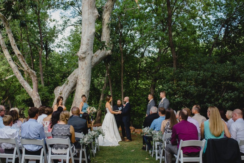 LAuberge small wedding in front of trees creekside