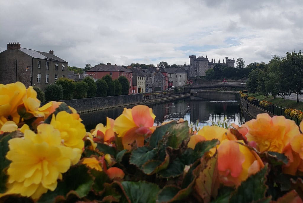Flowers on a bridge looking down the river in Kilkenny