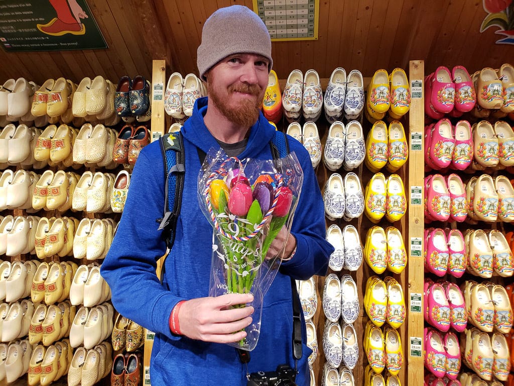 holding wooden flowers at the Dutch Wooden Shoes Workshop in Zaanse Schans
