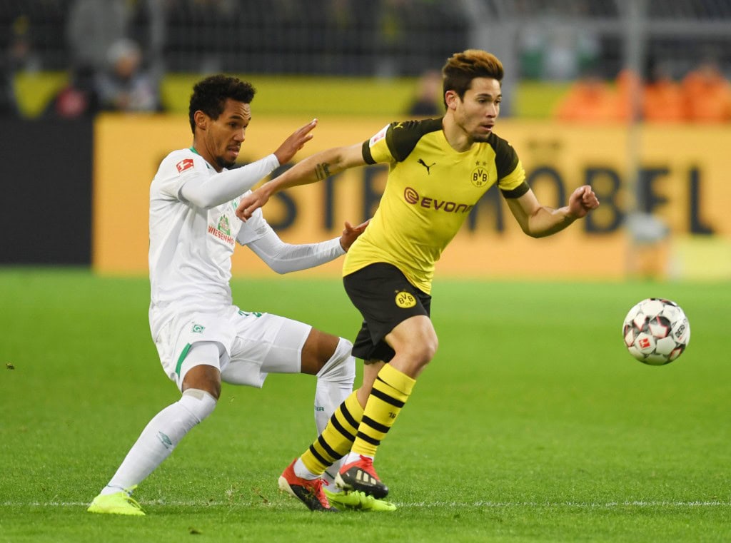 Dortmund's Portuguese defender Raphael Guerreiro and Bremen's Czech defender Theodor Gebre Selassie vie for the ball during the German first division Bundesliga football match Borussia Dortmund vs Werder Bremen in Dortmund, western Germany, on December 15, 2018. (Photo by Patrik STOLLARZ / AFP) / RESTRICTIONS: DFL REGULATIONS PROHIBIT ANY USE OF PHOTOGRAPHS AS IMAGE SEQUENCES AND/OR QUASI-VIDEO (Photo credit should read PATRIK STOLLARZ/AFP/Getty Images)