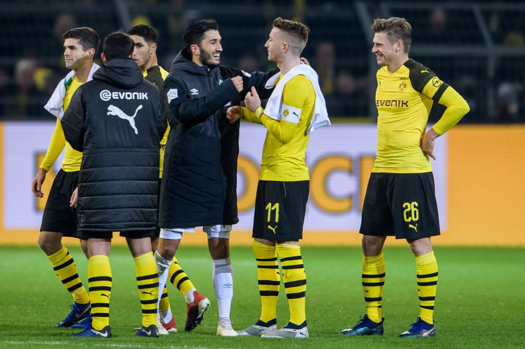 DORTMUND, GERMANY - DECEMBER 15: Nuri Sahin of Bremen with Marco Reus and Lukasz Piszczek after the Bundesliga match between Borussia Dortmund and SV Werder Bremen at the Signal Iduna Park on December 15, 2018 in Dortmund, Germany. (Photo by Jörg Schüler/Getty Images)