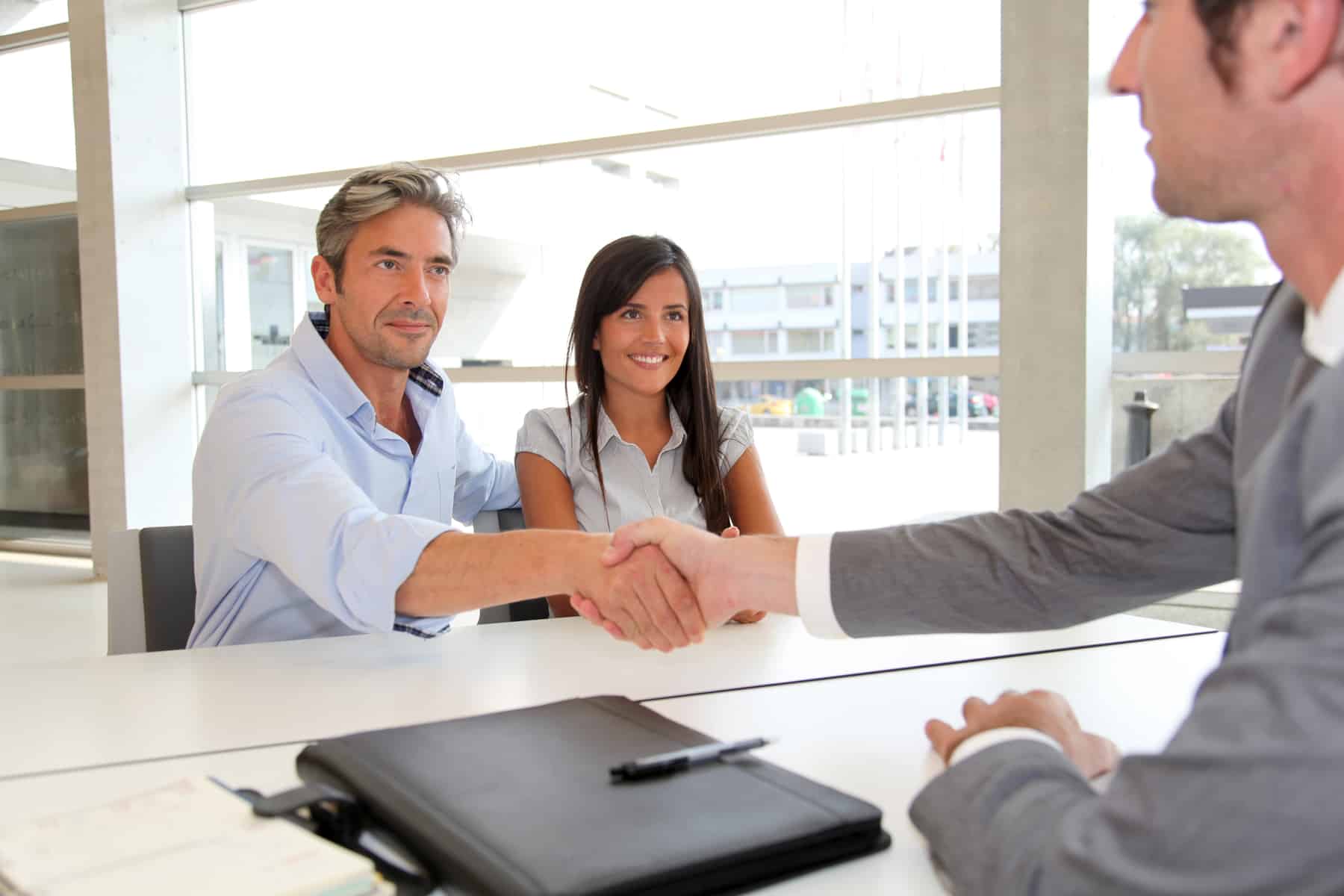 Man giving handshake to real-estate-agent Man giving handshake to real-estate-agent