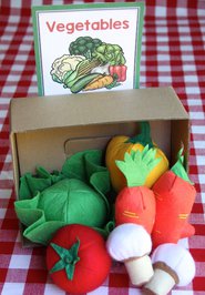 Photo of fabric vegetables in a box with a sign saying "Vegetables."