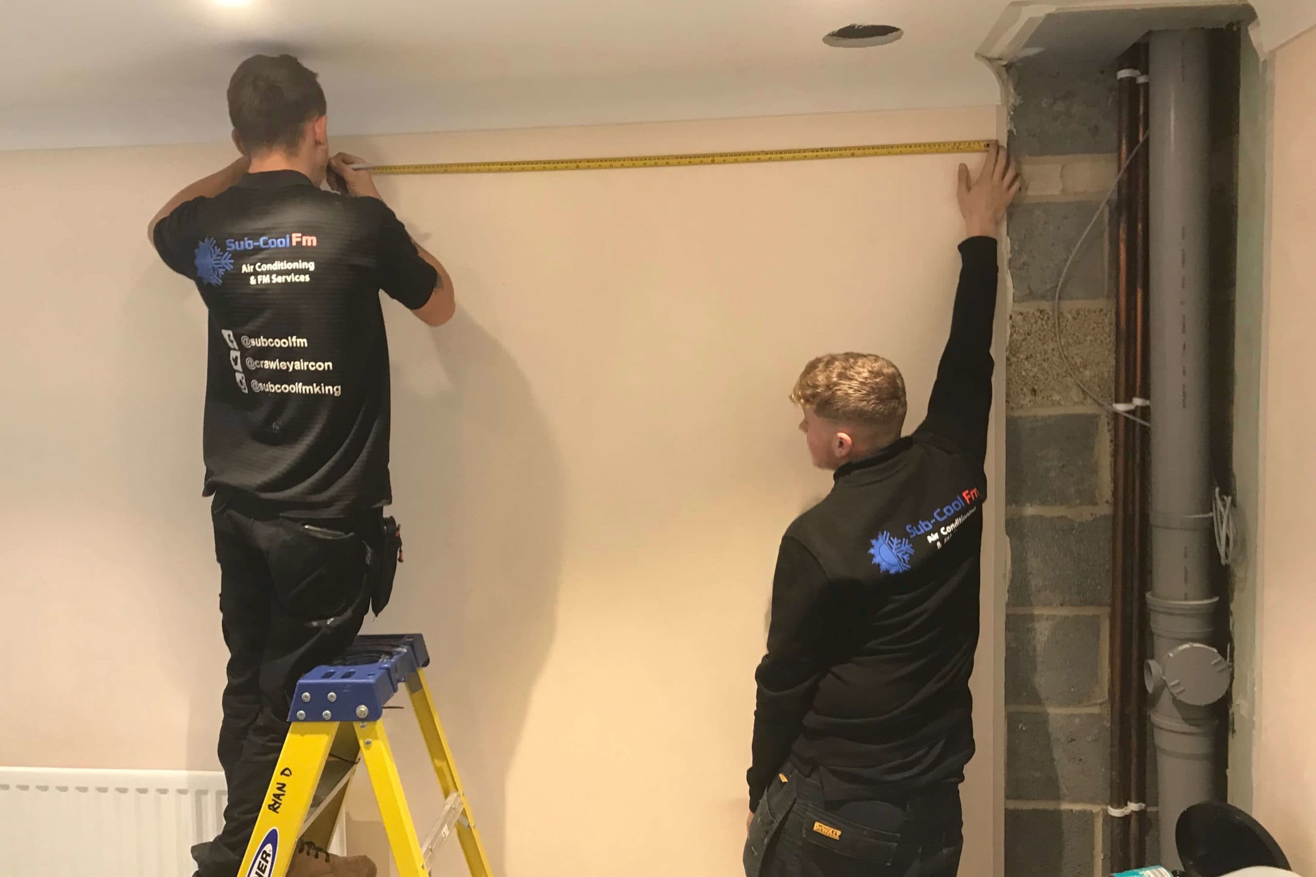 2 SuCoolFm engineers measuring for air conditioning installation