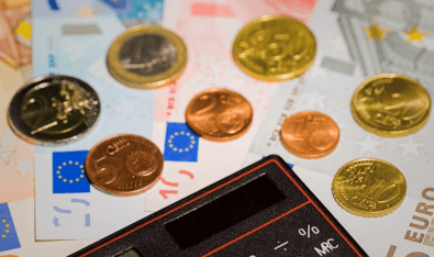 Money transfer image of a calculator and some euros