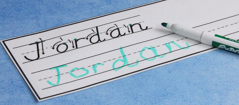 Photo of a card that shows how to form the letters in the name "Jordan." The student wrote the name on the line below.