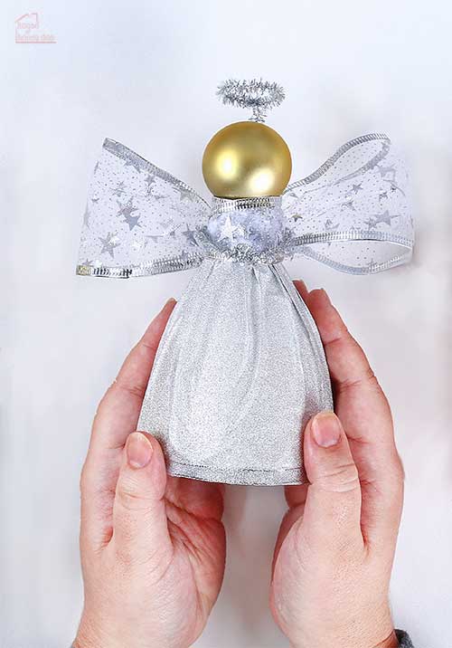 hands holding finished silver angel