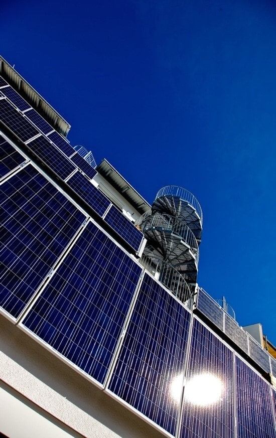 Fassade des Greenhouse in Freiburg Rieselfeld, bei dem die Balkongeländer selbst durch PV Module elektrische Energie für den Eigenverbrauch generieren. Das Gebäude ist selbst an heißen Sommertagen ohne Klimaanlage wohltemperiert.