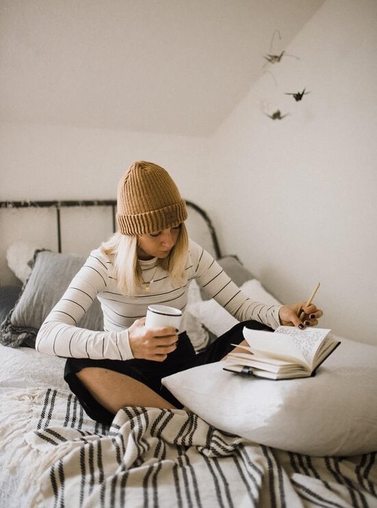scripting morning routine woman writing in bed