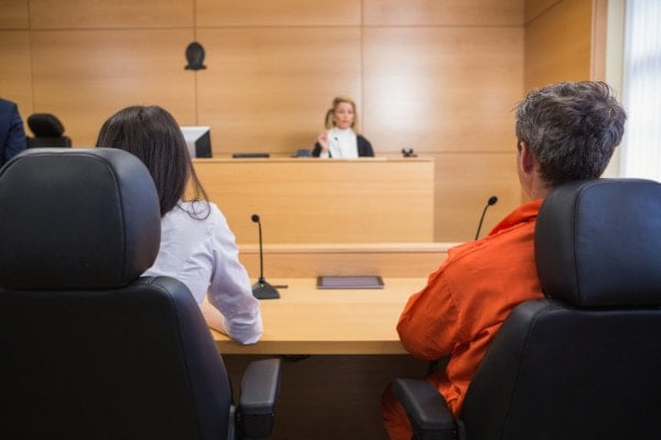 Lawyer and client listening to judge in the court room Lawyer and client listening to judge in the court room