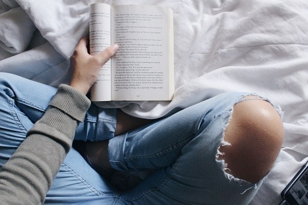 reading self isolation person reading on bed