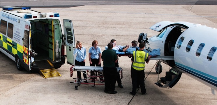 Medical Crew loading a patient into an air ambulance.