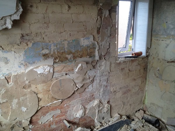 Exposed Brickwork After Stripping Wall Tiles With Bathroom Installation In Leeds