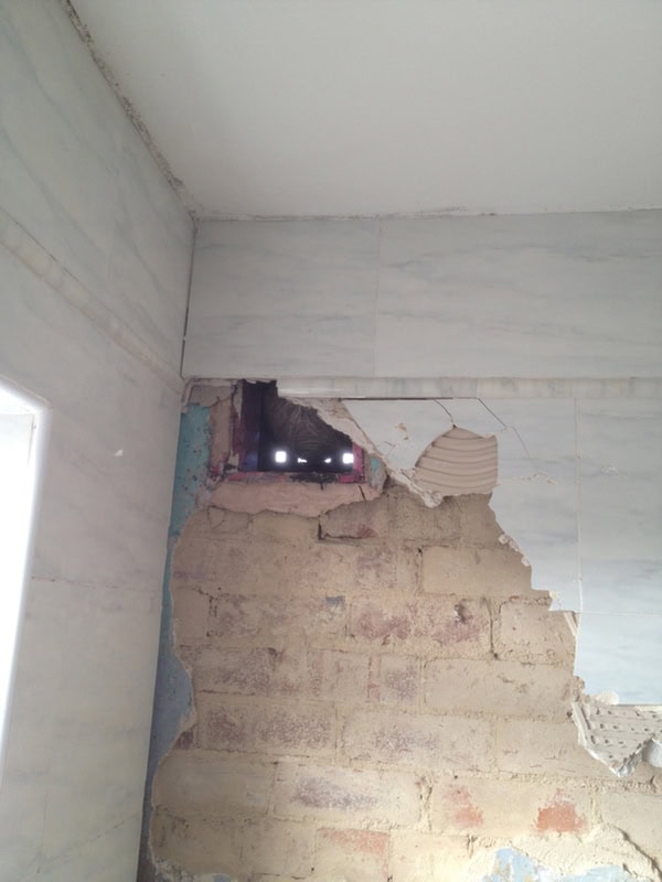 Removing Tiles Brings Plasterboard With Them With Bathroom Installation In Leeds