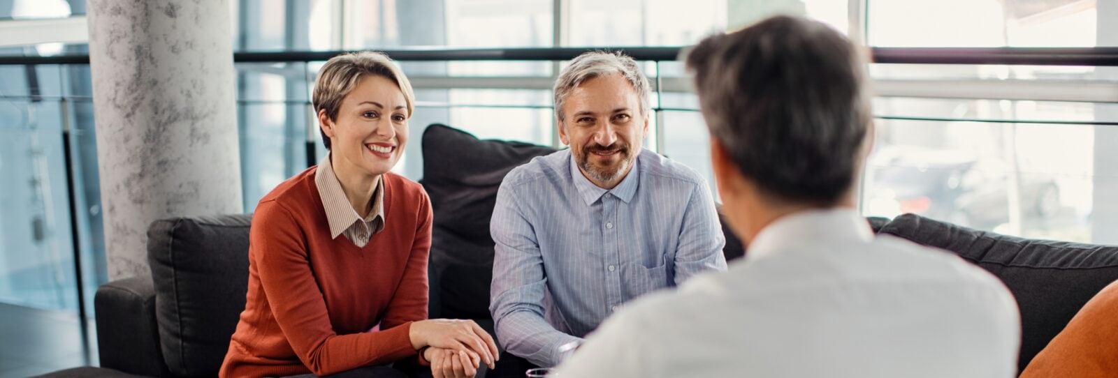 Mature couple speaking with advisor