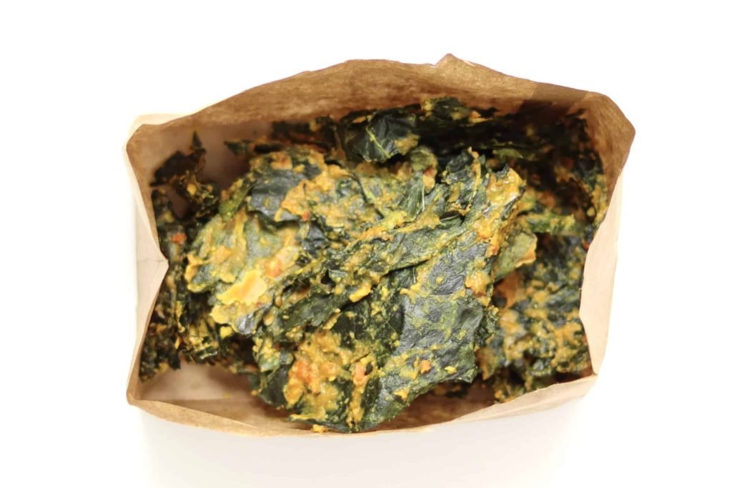 Kale chips stored in a brown paper bag