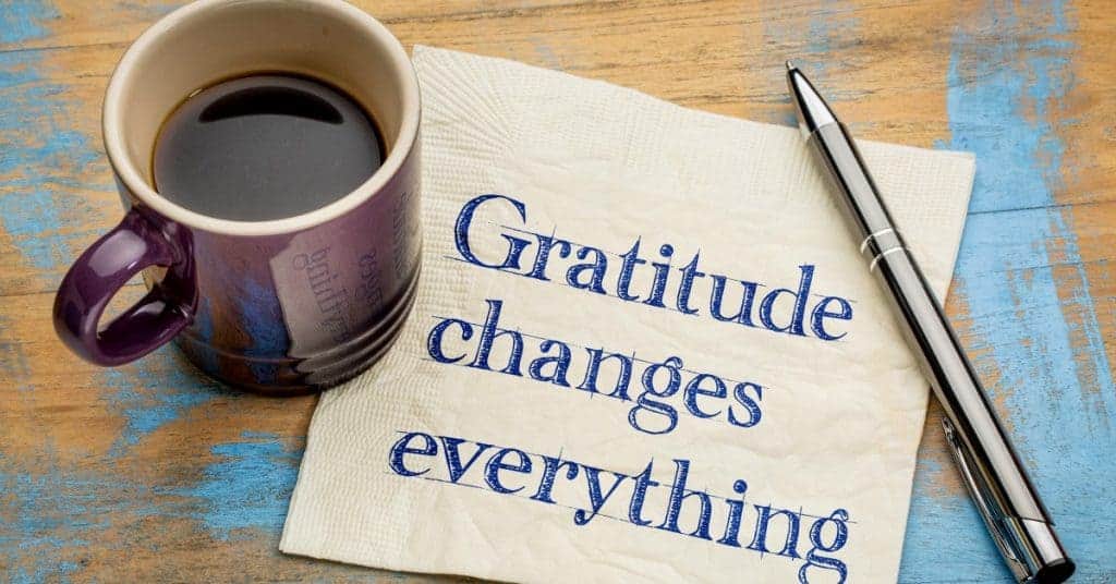 Gratitude changes everything - handwriting on a napkin with a cup of espresso coffee