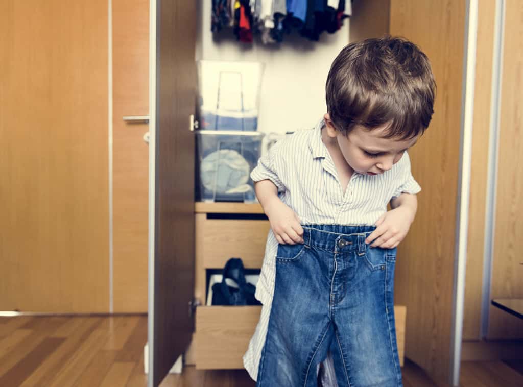 Child getting dressed by himself
