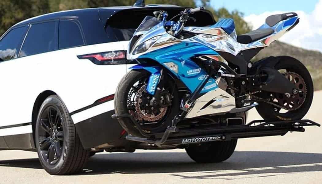 motorcycle sports in a hitch carrier in white car