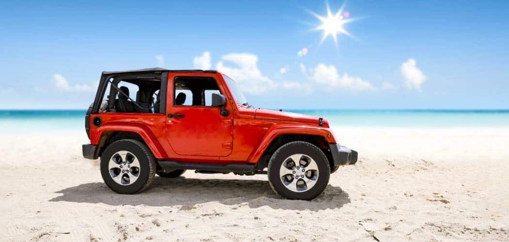 ed jeep with soft top in a beach