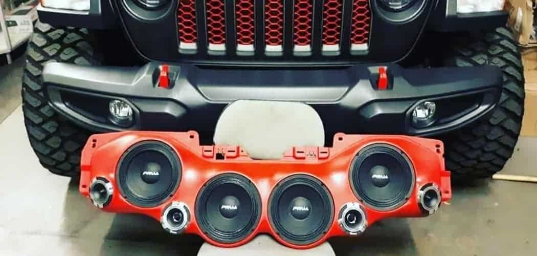 speakers in sound bar in front of red jeep wrangler