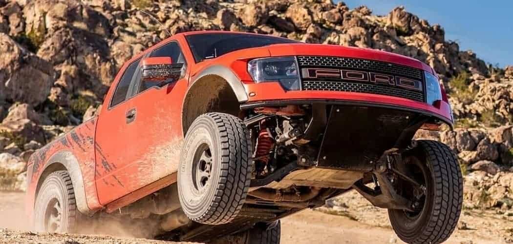 ford f150 red with shocks in hill