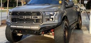 gray ford f150 with shocks in street