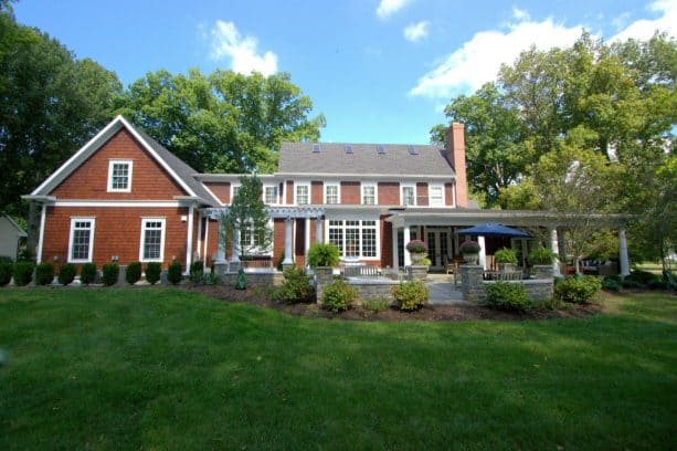 elegant pergola attached to a sable colored roof