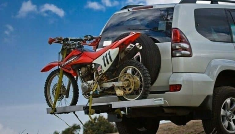 motorcycle in a hitch carrier in suv car