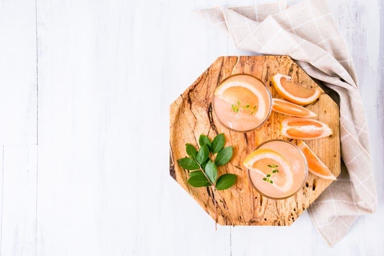  alcoholic beverage cocktails on a wooden tray shot from above as gift ideas for dads