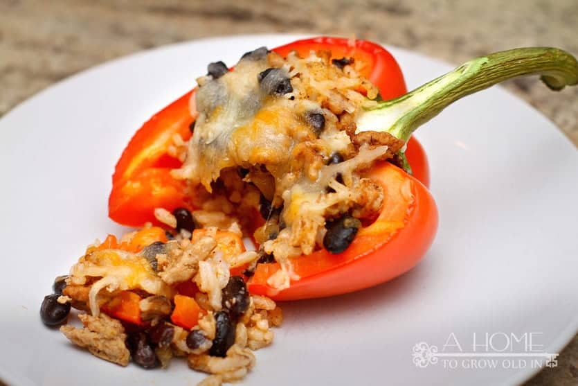 bite taken of a turkey stuffed bell pepper with cheese