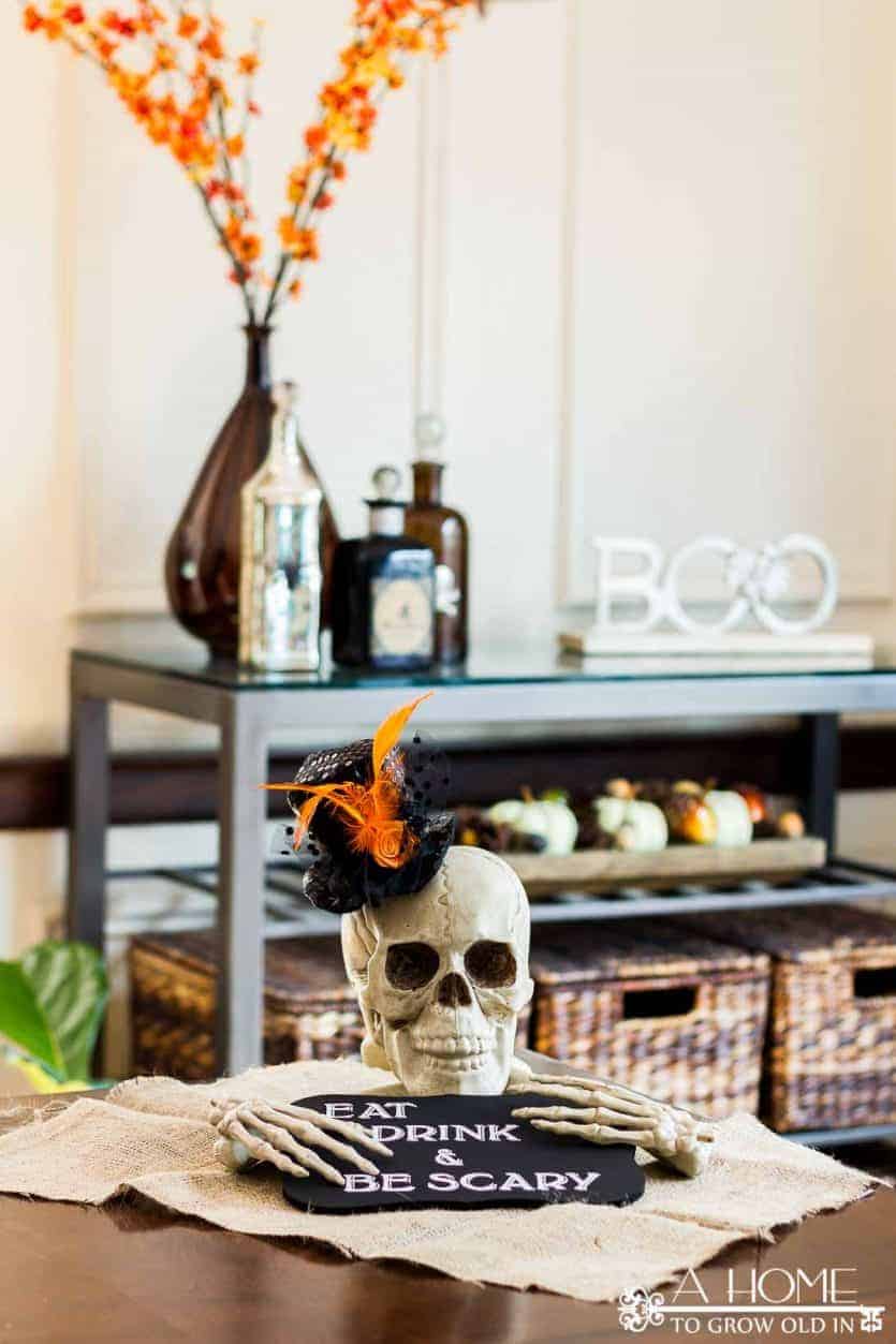 DIY halloween skull and bones centerpiece with eat drink and be scary sign