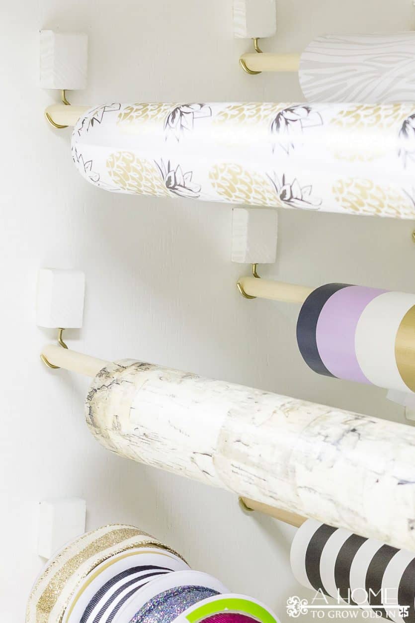 It's easy to repurpose an old armoire into a beautiful and organized gift wrapping station for your craft room! Lots of ideas on how to DIY this yourself!
