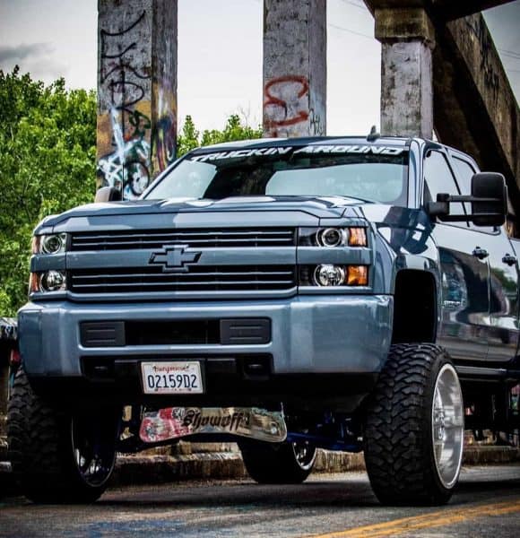 chevy silverado truck with shocks in bridge background