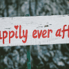"Happily ever after" sign on a tree. Love & compassion, your way to paradise.