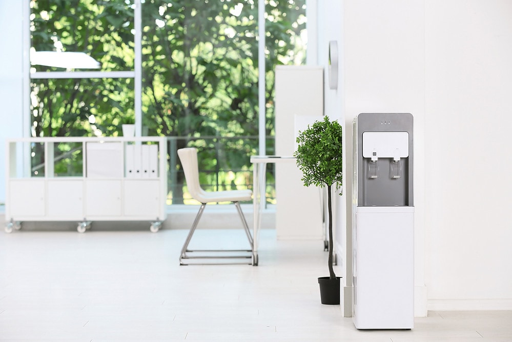 Modern water cooler in stylish office interior
