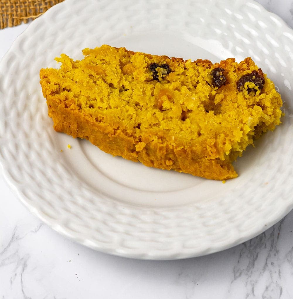 Slice of mango bread on white plate