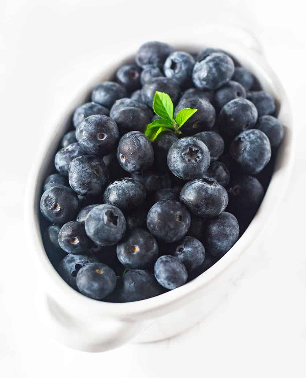 Blueberries For Blueberry Banana Smoothie in a white bowl