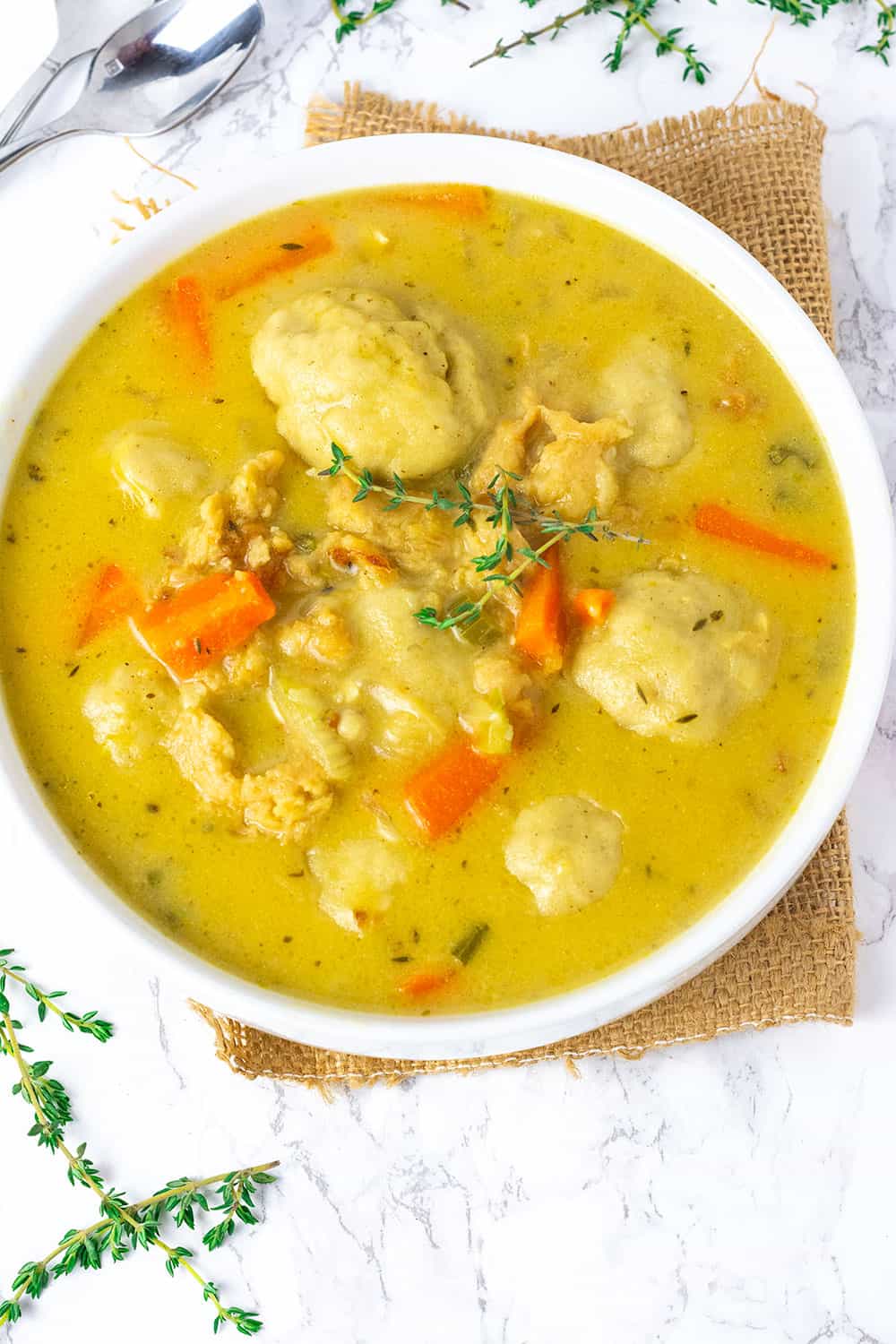 a white bowl of vegan chicken and dumplings