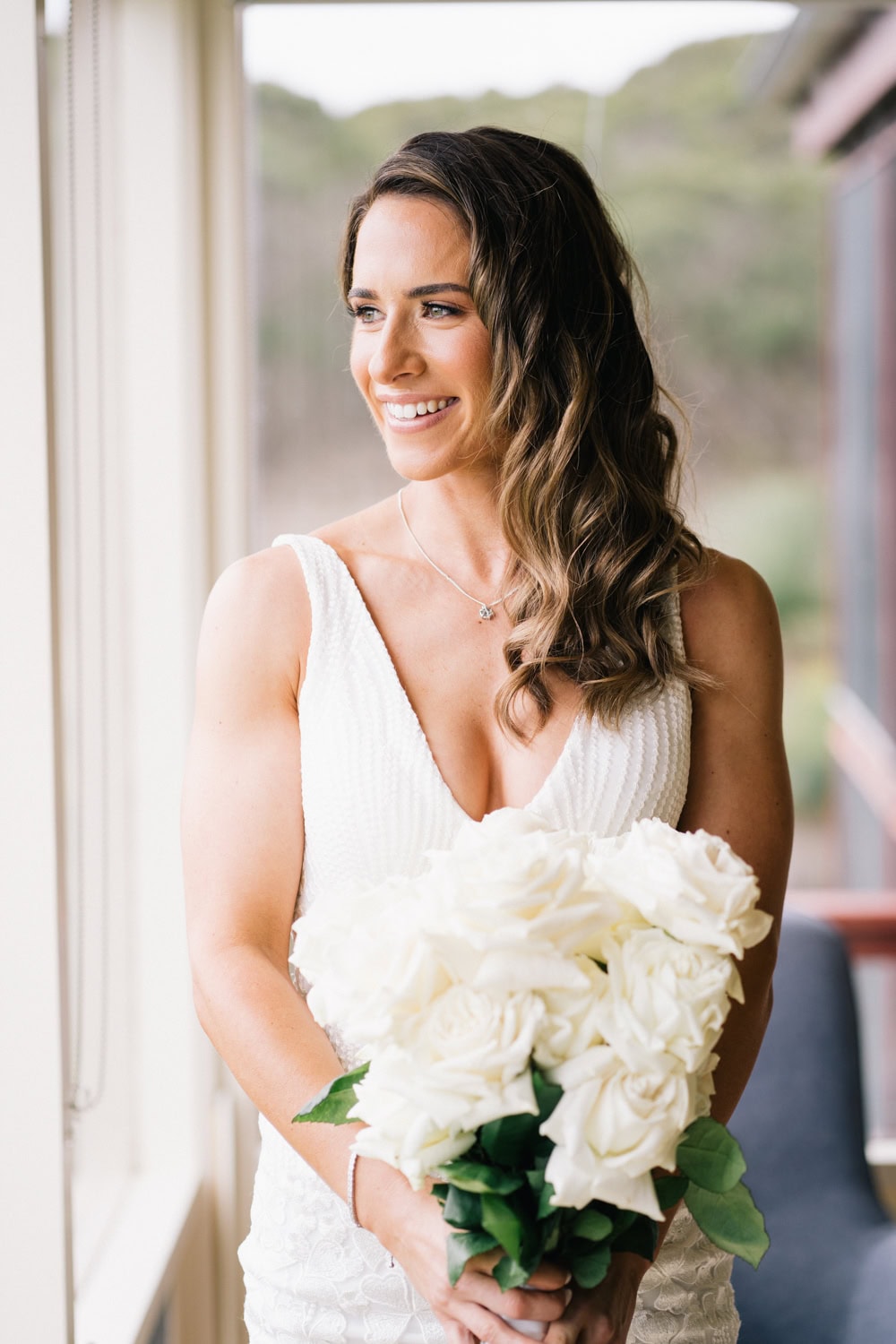 Bride smiling out the window