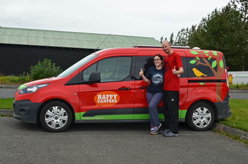 Brooke and Buddy posing outside their Happy Campers Van in Iceland