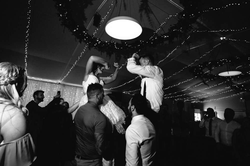 Bride & Groom Dancing on Shoulders of wedding guests at the Morphettville Racecourse Wedding Reception