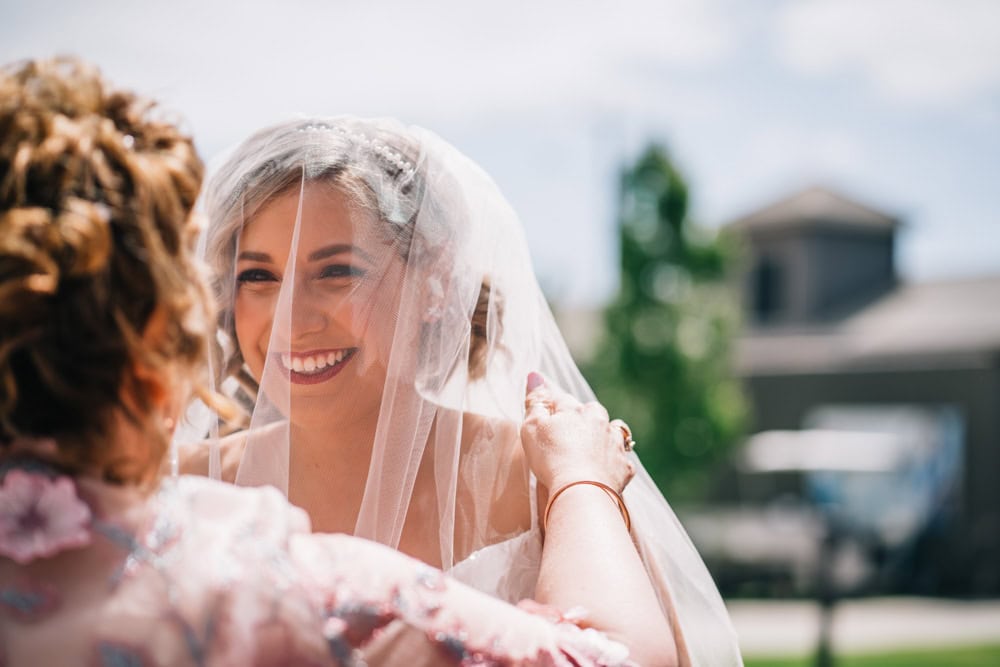 bride with veil smiling