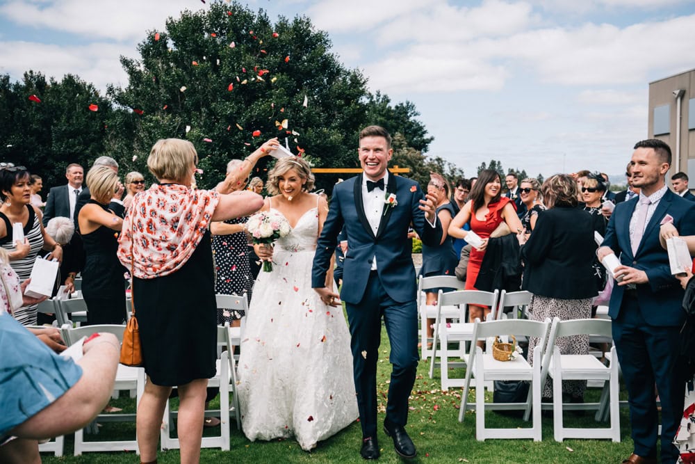 bride with groom showered in flower petals