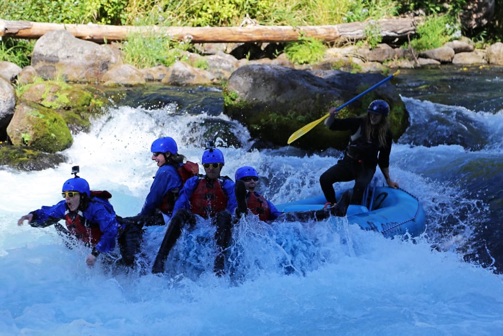 Brooke looks like she is jumping out of the raft while 'Riding the Bull' on the White Salmon River.