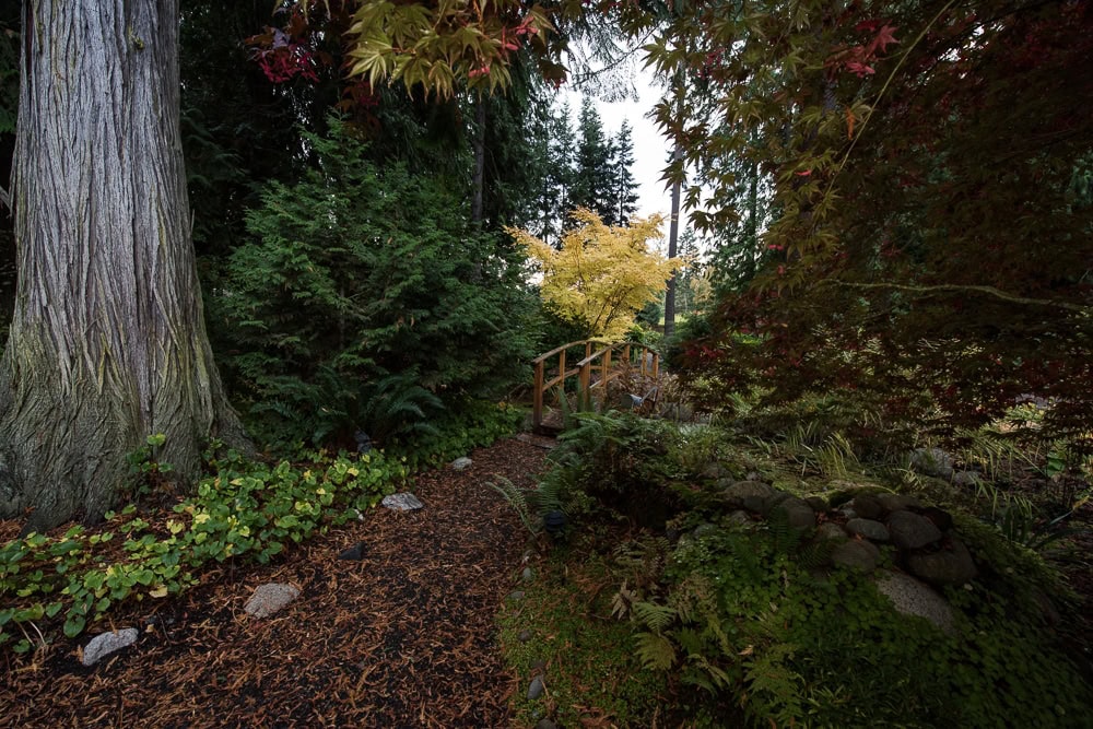 Beautifully landscaped walking trail with bridge over a stream