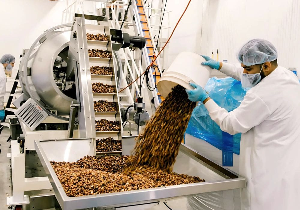 A worker prepares pulse-based snacks for Three Farmers Food