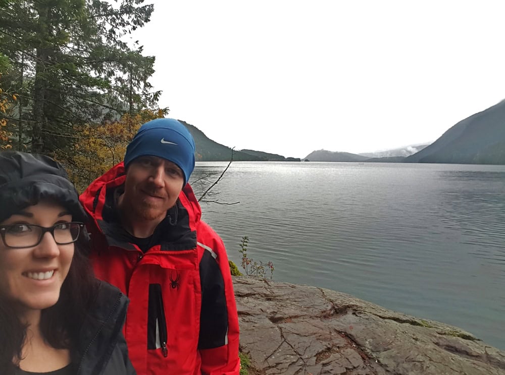 Brooke and Buddy on the shore of a foggy sproat lake